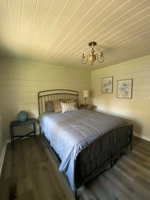 Log cabin bedroom with chandelier lighting