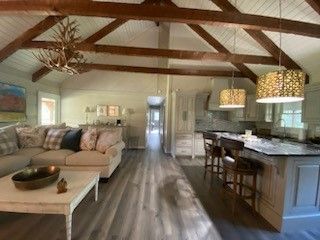 Renovated log cabin open-concept living room and kitchen